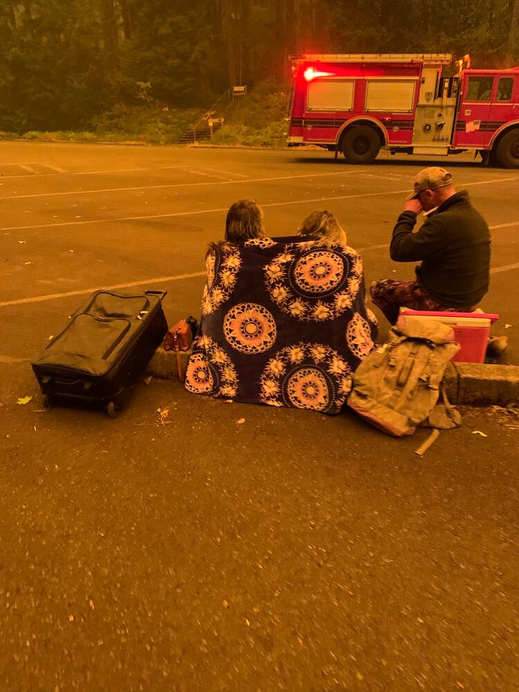 *EMBARGO: No electronic distribution, Web posting or street sales before THURSDAY 3:01 a.m. ET SEPT. 17, 2020. No exceptions for any reasons. EMBARGO set by source.**An image provided by Cindy Neblett, evacuees amidst the fire in Detroit, Ore. After raging wildfires left them trapped on the shores of a reservoir near Detroit, Ore., dozens of people and nine firefighters mounted a last stand, hoping for a miracle. (Cindy Neblett via The New York Times)-- NO SALES; FOR EDITORIAL USE ONLY WITH NYT STORY ORE-WILDFIRES-ESCAPE BY JACK HEALY AND MIKE BAKER FOR SEPT. 16, 2020. ALL OTHER USE PROHIBITED. --