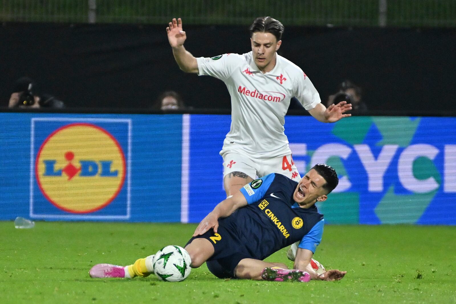 Celje's Juanjo Nieto is challenged by Fiorentina's Nicolo Fagioli, rear, during the Europa Conference League first-leg quarterfinal soccer match between Celje and Fiorentina in Celje, Slovenia, Thursday, April 10, 2025. (AP Photo/Igor Kupljenik)