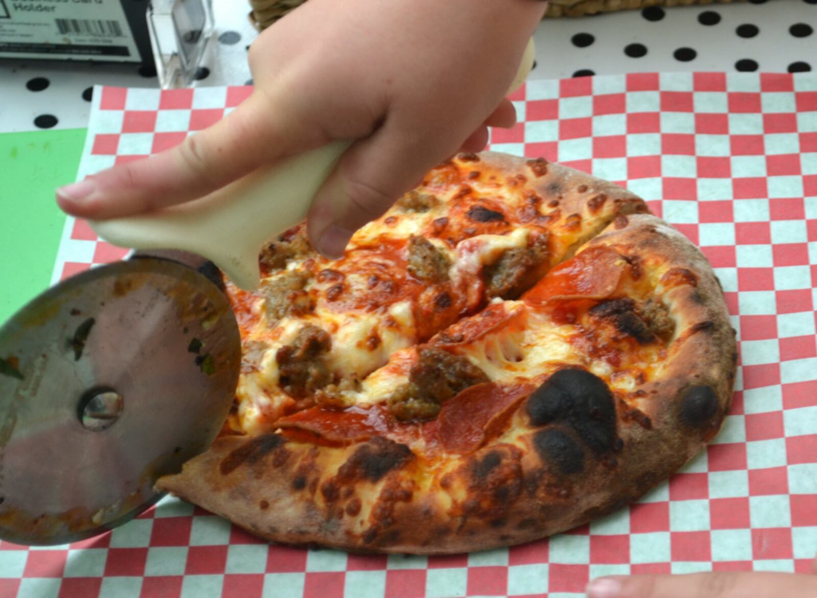 Neopolitan-style pizzas come out of Bella Sorella's ovens with blackened and blistered spots that add flavor. Photo by Mark Fisher