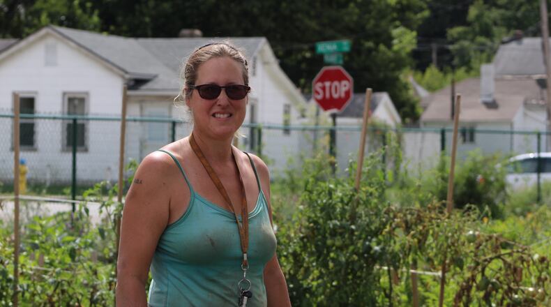 Lisa Helm, the founder of Dayton Urban Grown Farm, stands among the plantings at the co-op and training farm. Helm also founded Garden Station, which was evicted from a city-owned property last year. CORNELIUS FROLIK / STAFF