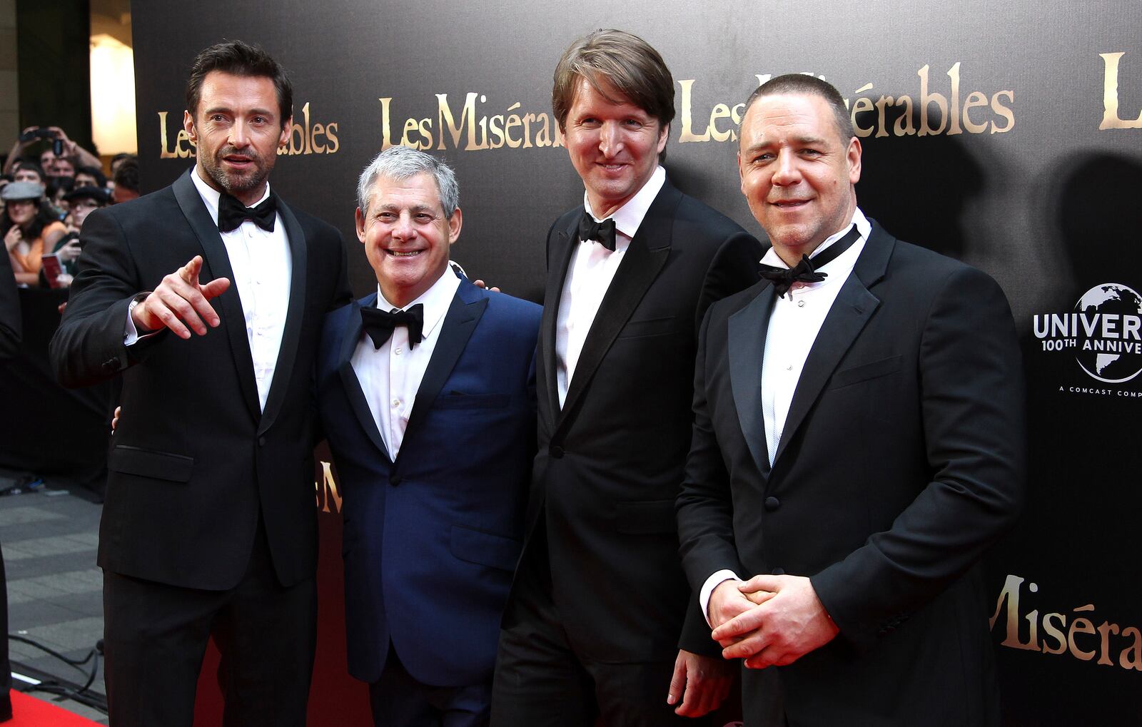 FILE - Hugh Jackman, from left, Cameron Mackintosh, Tom Hooper, and Russell Crowe pose for a photo as they walk down the red carpet at the premier of "Les Miserables" in Sydney, Australia, Friday, Dec. 21, 2012. (AP Photo/Rob Griffith, File)