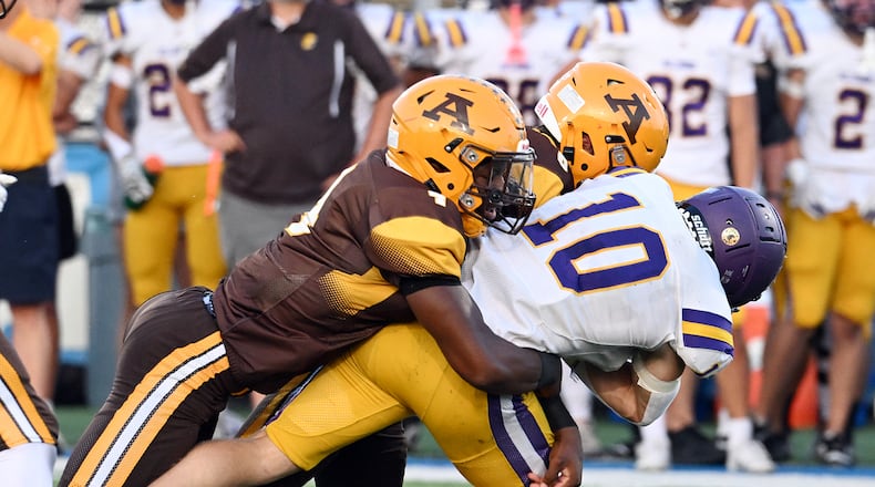 Bellbrook High School senior Vincent Epifano is tackled by two Alter players during their game on Friday, Sept. 19 at Miamisburg High School's Holland. The Knights won 21-3. NICK FALZERANO / CONTRIBUTED PHOTO