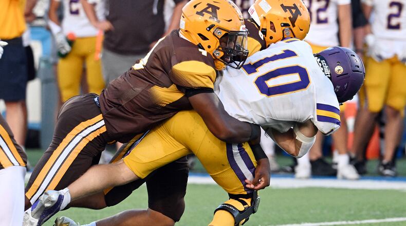 Bellbrook High School senior Vincent Epifano is tackled by two Alter players during their game on Friday, Sept. 19 at Miamisburg High School's Holland. The Knights won 21-3. NICK FALZERANO / CONTRIBUTED PHOTO