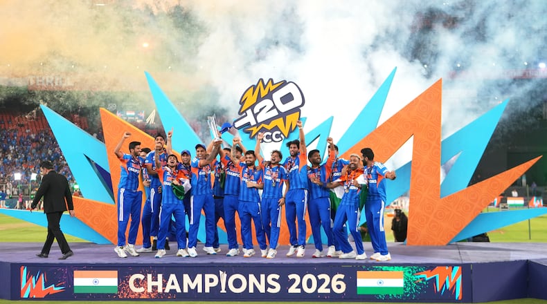 India's players celebrate with the trophy after winning the T20 World Cup final match against New Zealand in Ahmedabad, India, Sunday, March 8, 2026. (AP Photo/Ajit Solanki)