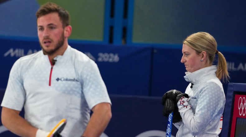 United States' Cory Thiesse and Korey Dropkin look on during the mixed doubles round robin phase of the curling competition against Britain, at the 2026 Winter Olympics, in Cortina d'Ampezzo, Italy, Saturday, Feb. 7, 2026. (AP Photo/Misper Apawu)