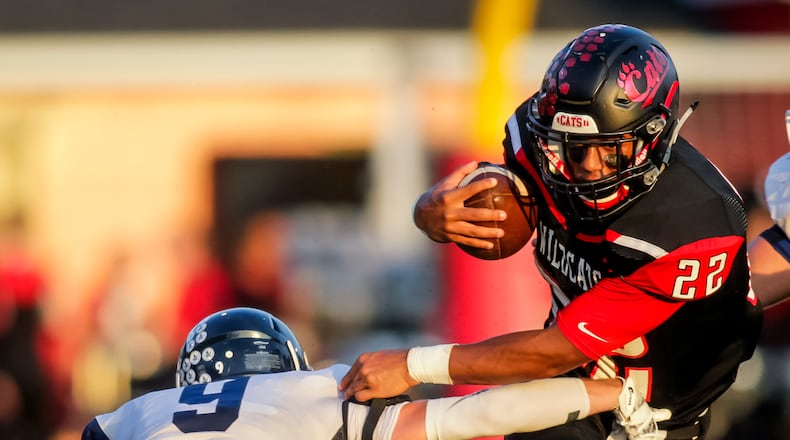 Valley View’s Lane Murphy tries to tackle Franklin’s Ryan Montgomery as he carries the ball during their game Friday, Sept. 23 at Veterans Memorial Field at Atrium Stadium in Franklin. The Wildcats defeated the Spartans 41-8. NICK GRAHAM/STAFF