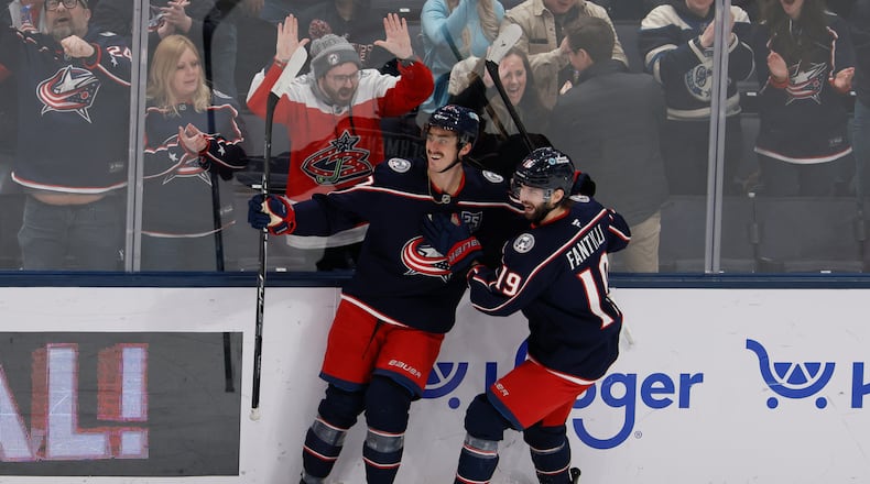 Columbus Blue Jackets' Mason Marchment, left, celebrates his hat trick against the Tampa Bay Lightning with teammate Adam Fantilli during the third period of an NHL hockey game, Saturday, Jan. 24, 2026, in Columbus, Ohio. (AP Photo/Jay LaPrete)