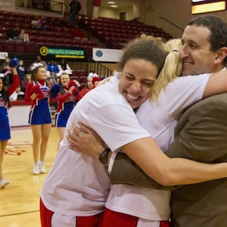 University of Dayton women's basketball coach Jim Jabir gets a hug from two of his players - Casey Nance and Elle Queen – after the Flyers won the 2012 Atlantic 10 Tournament and got berth in the NCAA Tournament. CONTRIBUTED PHOTO