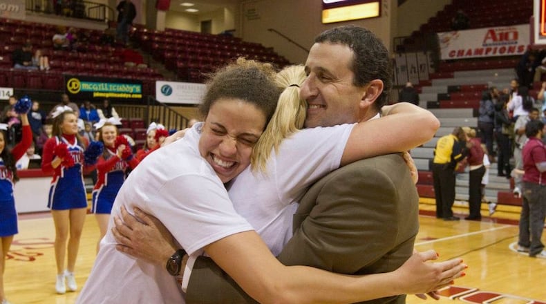 University of Dayton women's basketball coach Jim Jabir gets a hug from two of his players - Casey Nance and Elle Queen – after the Flyers won the 2012 Atlantic 10 Tournament and got berth in the NCAA Tournament. CONTRIBUTED PHOTO