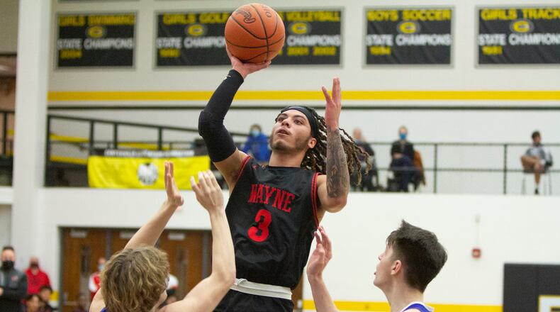 Wayne senior Malcolm Curry shoots over Cincinnati St. Xavier's Jonny Vanover during Saturday night's Division I district final at Centerville High School. Curry scored 13 points in the Warriors' 81-65 loss. Jeff Gilbert/CONTRIBUTED