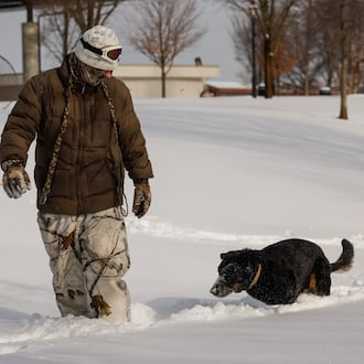 Jeff Cornwell plays in the snow with his rescued three-legged German shepherd, Wolfie, on Monday, Jan. 26, 2026, at Marcum Park in Hamilton. NICK GRAHAM/STAFF