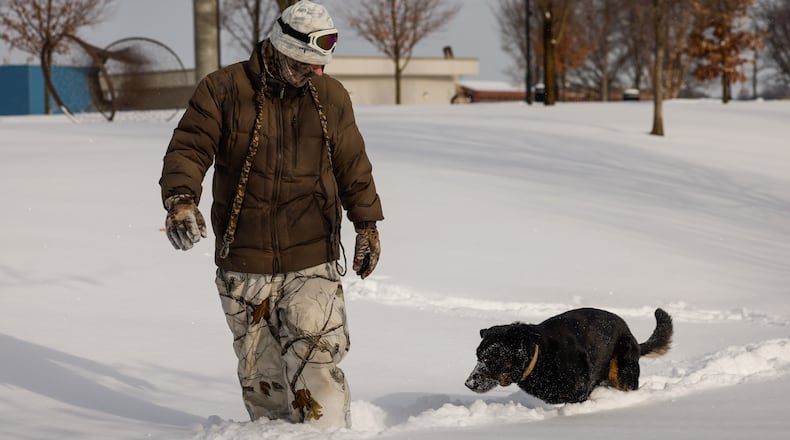 Jeff Cornwell plays in the snow with his rescued three-legged German shepherd, Wolfie, on Monday, Jan. 26, 2026, at Marcum Park in Hamilton. NICK GRAHAM/STAFF