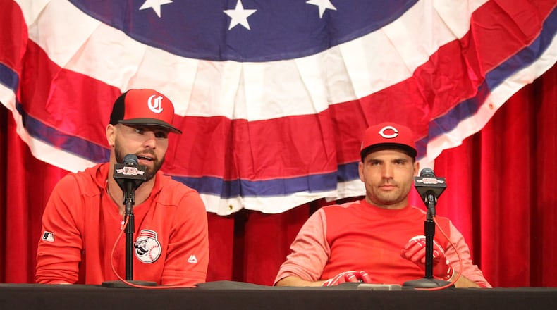 Jesse Winker and Joey Votto talk during a press conference on Reds Opening Day on Thursday, March 28, 2019, at Great American Ball Park in Cincinnati. David Jablonski/Staff