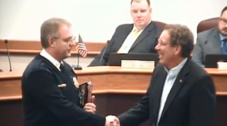Huber Heights Fire Division Chief Mark Ashworth shakes hands with retiring fire chaplain Pastor Dennis Dobbins. CONTRIBUTED