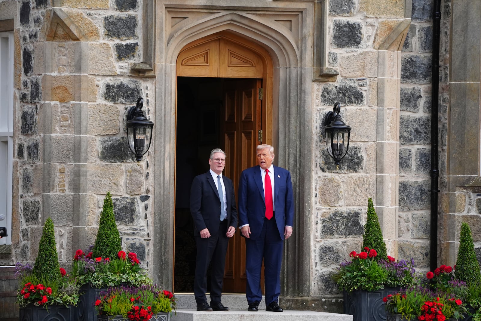U.S. President Donald Trump, right, and British Prime Minister Keir Starmer walk at Trump International Golf Links in Aberdeenshire, Scotland, Monday, July 28, 2025. (Jane Barlow/Pool Photo via AP)
