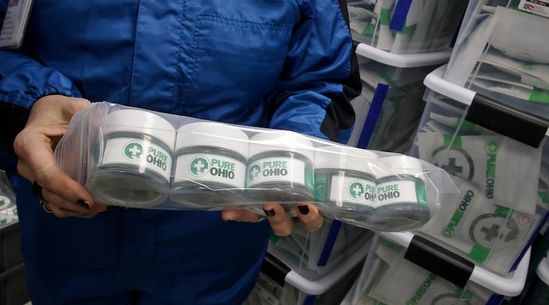 Some of the packaged cannibus ready for the dispensary Monday, Dec. 4, 2023 at the Pure Ohio Wellness production facility in Clark County. BILL LACKEY/STAFF