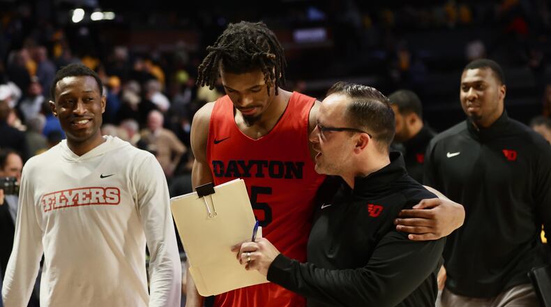 Dayton's DaRon Holmes II and Andy Farrell leave the court after a victory against Virginia Commonwealth on Tuesday, Feb. 7, 2023, at the Siegel Center in Richmond, Va. David Jablonski/Staff