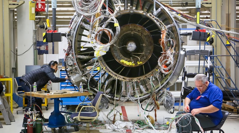 Engineers work on a LEAP commercial jet test engine at GE Aviation in Evendale, Friday, Dec. 19, 2014. The engine, made by CFM, a joint venture between GE and French manufacturer Snecma, will be more fuel efficient and contain advanced materials. GREG LYNCH / STAFF