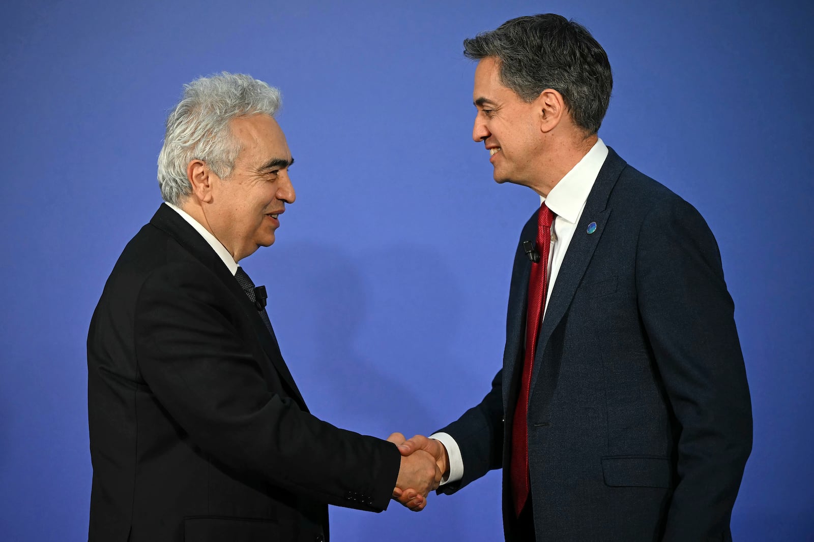 Britain's Secretary for Energy Security Ed Miliband, right, and Fatih Birol, Executive Director of the International Energy Agency (IEA) shake hands on day one of the International Summit on the Future of Energy Security at Lancaster House in London, Thursday April 24, 2025. (Justin Tallis/Pool via AP)