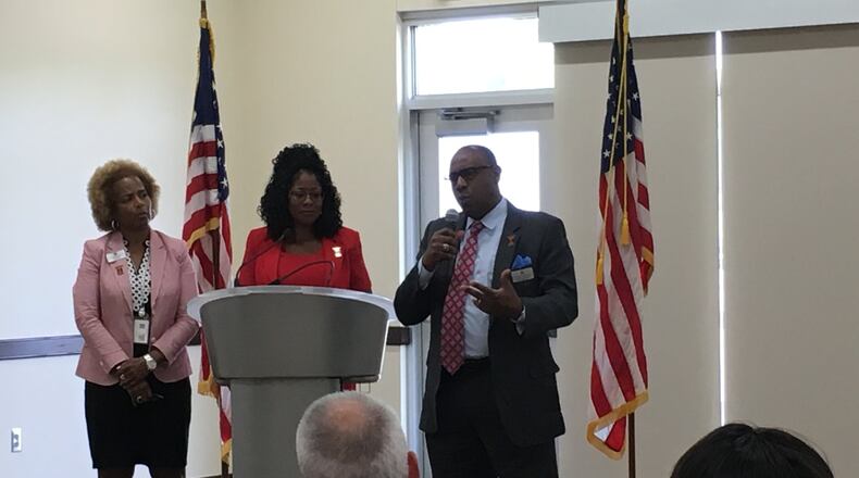 Trotwood-Madison schools interim superintendent Tyrone Olverson explains recent changes in the district as treasurer Janice Allen (left) and school board president Denise Moore look on Friday, Aug. 24, 2018. JOSH SWEIGART / STAFF