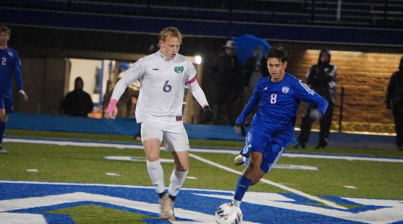 Badin High School senior Colt Long dribbles past Carroll sophomore Tadeas Fedorisin during their Division III regional semifinal match on Wednesday at Williamsburg High School. The Rams won 1-0 in penalty kicks. CHRIS VOGT / CONTRIBUTED