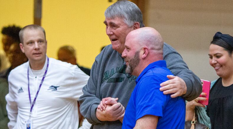 Chaminade Julienne head coach Charlie Szabo (right) is congratulated by former Eagles head coach Joe Staley after CJ's 64-59 victory over Alter in the Division II region final Saturday night at Butler High School. CONTRIBUTED/Jeff Gilbert