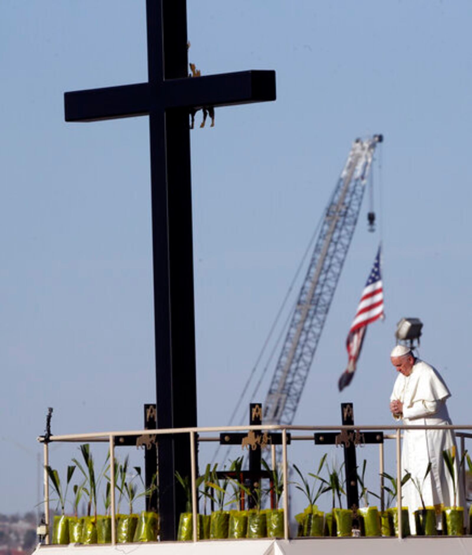 FILE - Pope Francis prays near the U.S.-Mexico border fence along the Rio Grande, in Ciudad Juarez, Mexico, Wednesday, Feb. 17, 2016. (AP Photo/Gregorio Borgia, file)