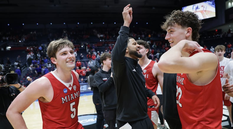 Miami University senior guard Peter Suder (left) and sophomore guard Brant Byers (right) celebrate on the court following an 89-79 win over Southern Methodist in an NCAA First Four game on Wednesday, March 18 at University of Dayton Arena. Byers scored 19 points. BRYANT BILLING / STAFF