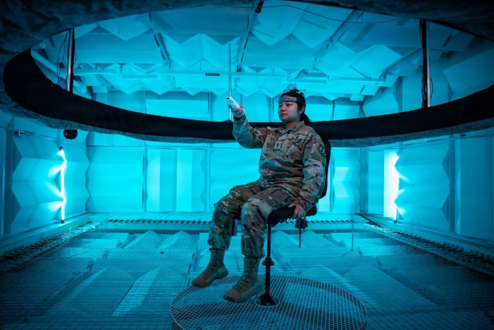 Second Lt. Hailey Ramos, human factors engineer, wears a motion capture headset as she identifies sound in the Spatial Hearing Anechoic Research Chamber Lab at Wright-Patterson Air Force Base, Sept. 11, 2025. (Air Force photo / Richard Eldridge)