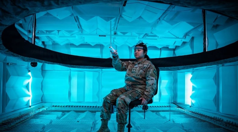 Second Lt. Hailey Ramos, human factors engineer, wears a motion capture headset as she identifies the direction of sound emitted from a circular array of speakers in the Spatial Hearing Anechoic Research Chamber Lab at Wright-Patterson Air Force Base, Sept. 11, 2025. Air Force photo/ Richard Eldridge