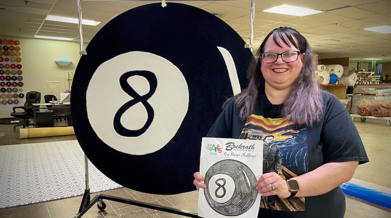 Bockrath Flooring & Rugs, a Dayton area business since 1959, has teamed up with We Care Arts to bring an artist’s drawing to life through a rug. Pictured is Rachel K., who won this year’s rug design challenge. NATALIE JONES/STAFF