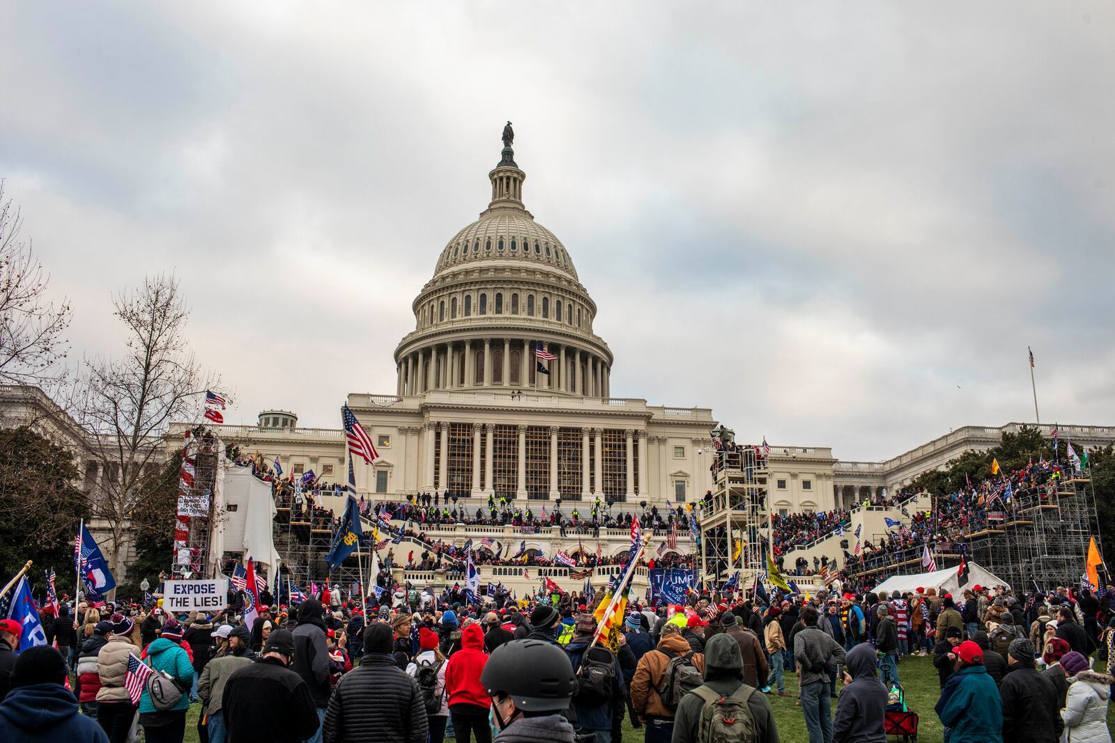 A pro-Trump mob storms the Capitol in Washington after a rally where the president spoke, urging them on, Jan. 6, 2021. Experts say the actions of President Donald Trump and his loyalists are harder to stop than a coup — citing anti-democratic slides in Turkey and Venezuela as closer examples. (Jason Andrew/The New York Times)