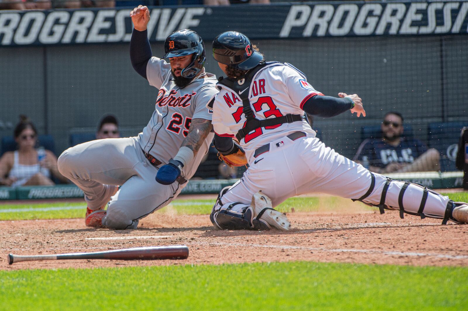 Detroit Tigers' Gleyber Torres, left, scores on a double by Matt Vierling as Cleveland Guardians' Bo Naylor is late with the tag during the 10th inning inning of a baseball game, Sunday, July 6, 2025, in Cleveland. (AP Photo/Phil Long)