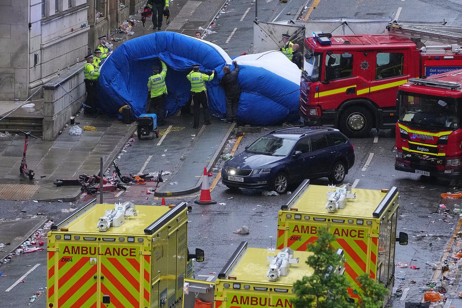 Police and emergency personnel deal with an incident after a car collided with pedestrians near the Liver Building during the Premier League winners parade in Liverpool, England, Monday, May 26, 2025.(AP Photo/Jon Super)