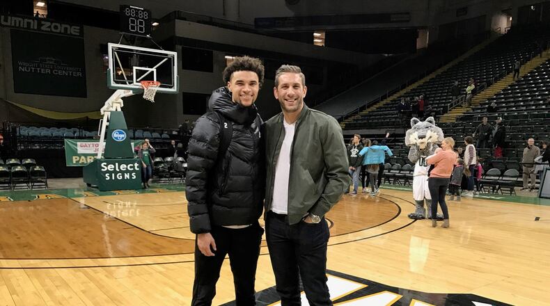 Wright State freshman Tanner Holden (left) and former Raiders standout, Dr. Drew Burleson after Saturday night’s game at the Nutter Center. Tom Archdeacon/CONTRIBUTED