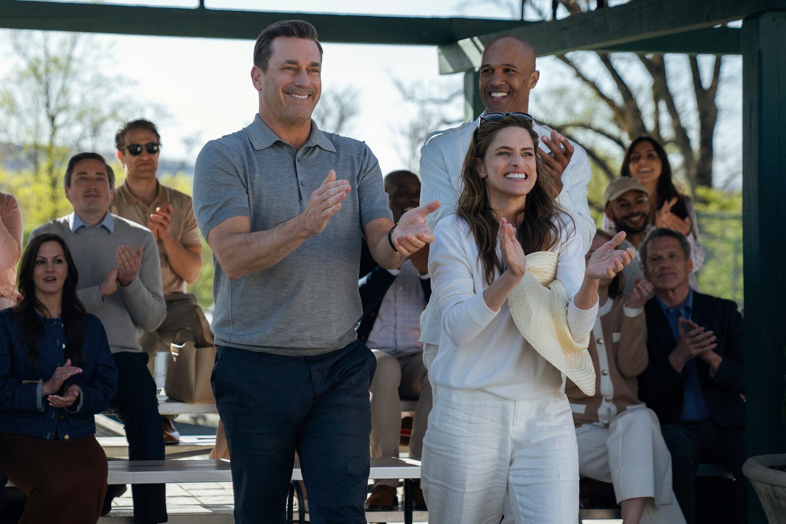 This image released by Apple TV+ shows Jon Hamm, from left, Amanda Peet and Mark Tallman in a scene from "Your Friends & Neighbors." (Jessica Kourkounis/Apple TV+ via AP)