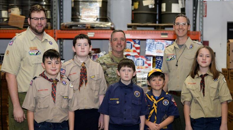 U.S. Air Force Chief Master Sgt. Keith Erb (center), U.S. Air Force Band of Flight chief enlisted manager, accepts four pallets of popcorn from the Boy Scouts of America, Miami Valley Council, and Pack 169 of Huber Heights, on Dec. 17 on behalf of Wright-Patterson Air Force Base. The popcorn will be distributed to organizations and Airmen at Wright-Patt. (U.S. Air Force photo/Wesley Farnsworth)