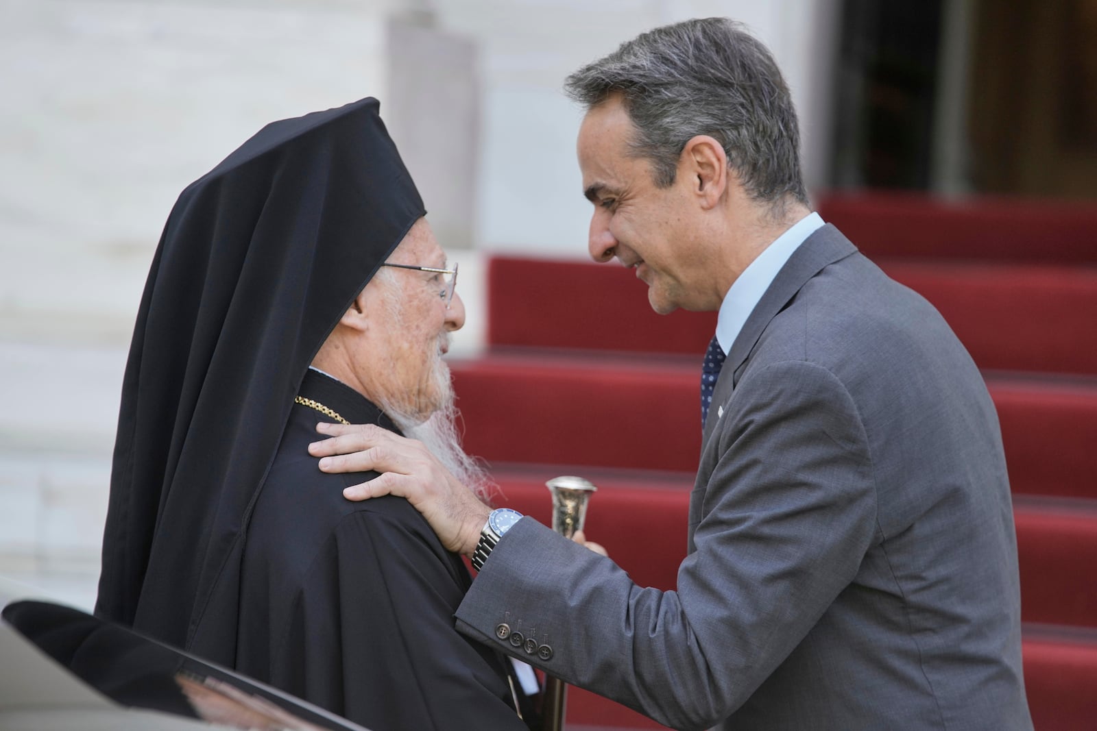 Greece's Prime Minister Kyriakos Mitsotakis, right, welcomes the Orthodox Ecumenical Patriarch Bartholomew before their meeting in Athens, on Thursday May 8, 2025. (AP Photo/Petros Giannakouris)