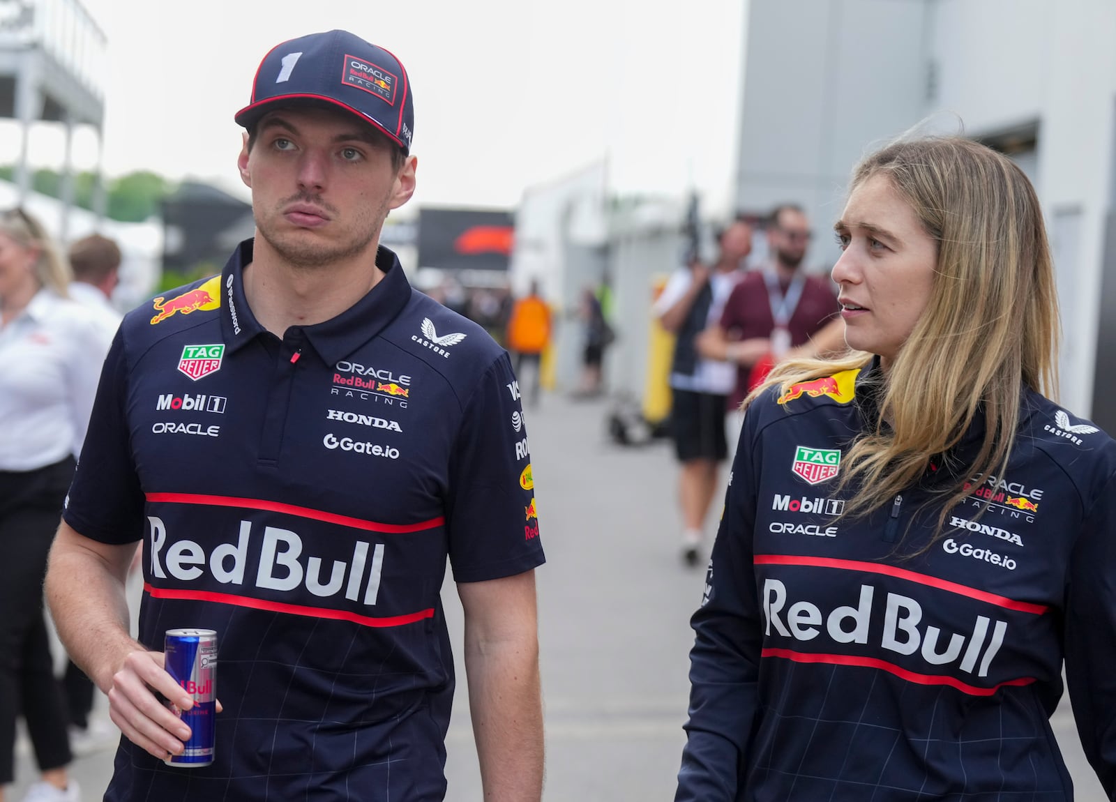 Red Bull Racing driver Max Verstappen, left, of the Netherlands, walks through the paddocks at the F1 Canadian Grand Prix auto race in Montreal, Thursday, June 12, 2025. (Christinne Muschi/The Canadian Press via AP)