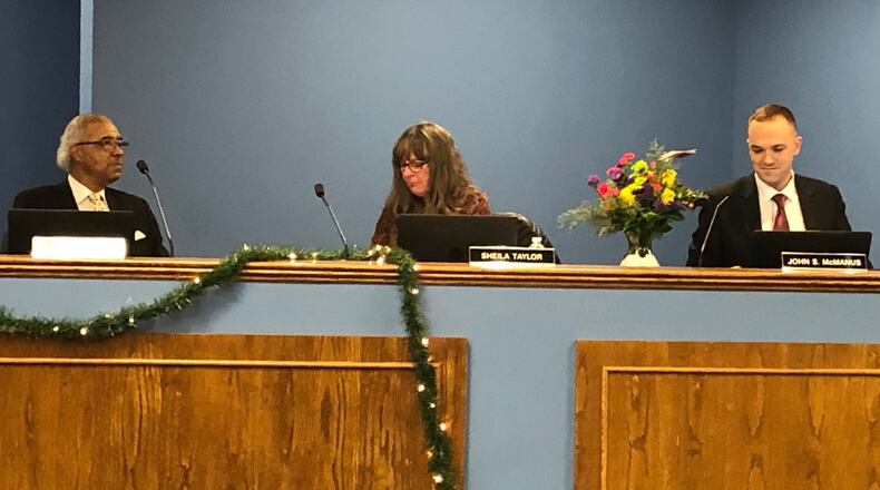 Outgoing Dayton school board members (from left) Robert Walker, Sheila Taylor and John McManus attended their final school board meeting Tuesday, Dec. 17, 2019. JEREMY P. KELLEY / STAFF