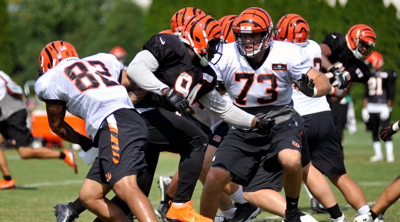 Cincinnati Bengals defensive end Chris Smith splits tight end Cethan Carter and tackle Eric Winston during Thursday’s practice at Paul Brown Stadium. JAY MORRISON/STAFF