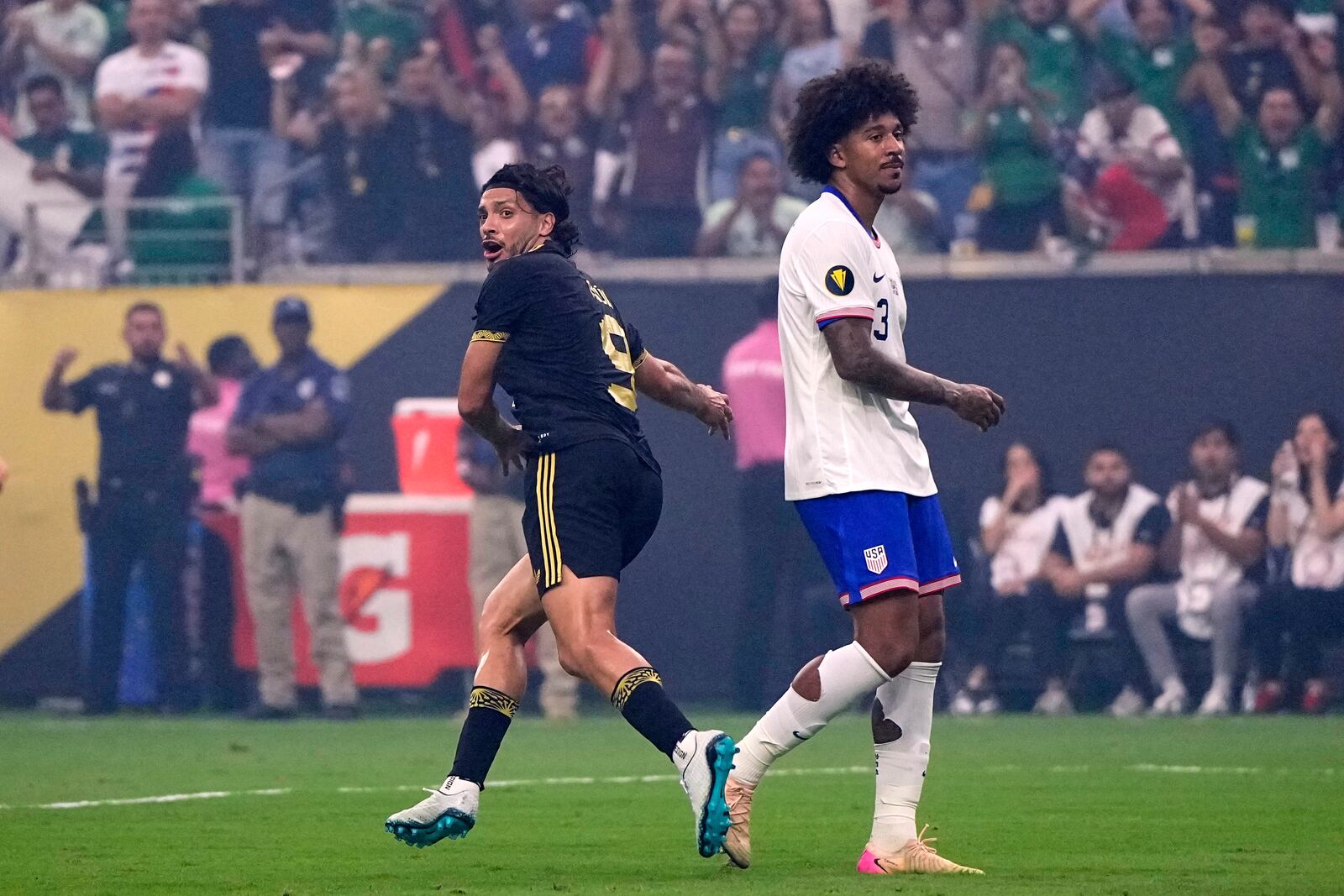Mexico forward Raúl Jiménez (9) celebrates after scoring as he sprints past United States defender Chris Richards (3) in the first half of the CONCACAF Gold Cup final soccer match in Houston, Sunday, July 6, 2025. (AP Photo/David J. Phillip)