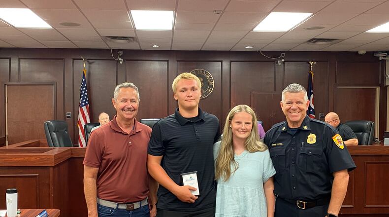 Franklin Public Works Director Steve Inman (far left) and Franklin Fire Chief Daniel Stitzel (far right) flank Jordan Milligan and Olivia DeHart, who were presented with valor awards Monday night. CONTRIBUTED