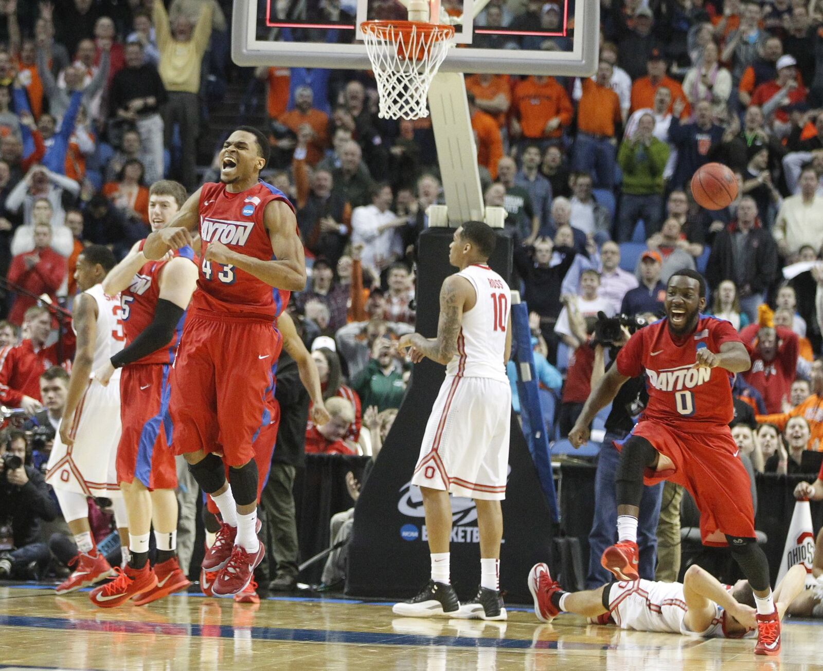 Dayton’s Vee Sanford, left, and Khari Price react after Ohio State Aaron Craft, back right, misses a shot at the final buzzer in the second round of the NCAA tournament on Thursday, March 20, 2014, at the First Niagara Center in Buffalo, N.Y. David Jablonski/Staff