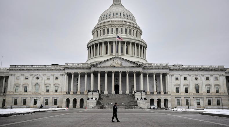 A U.S. Capitol Police officer patrols on the East Front of the U.S. Capitol, Friday, Feb. 6, 2026, in Washington. (AP Photo/Rahmat Gul)