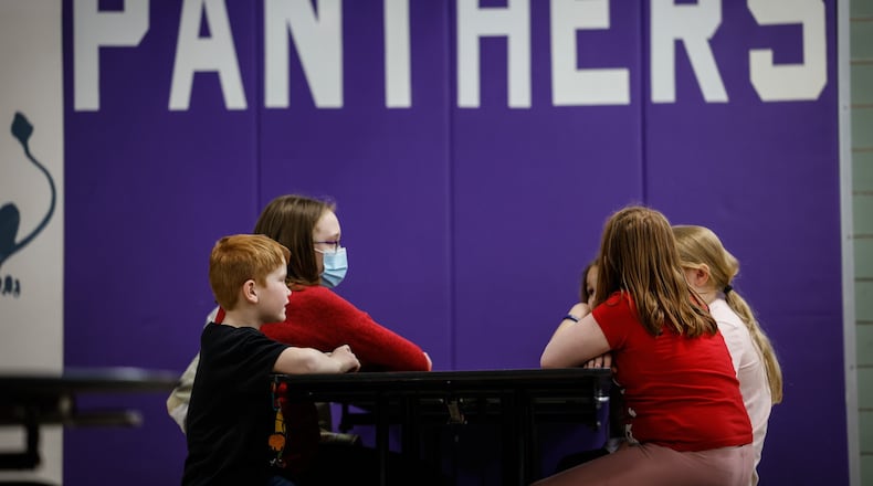 Students at Southdale Elementary School in Kettering chat after school during the after school child care program. Area schools are beginning to rescind mask mandates as case numbers drop. JIM NOELKER/STAFF