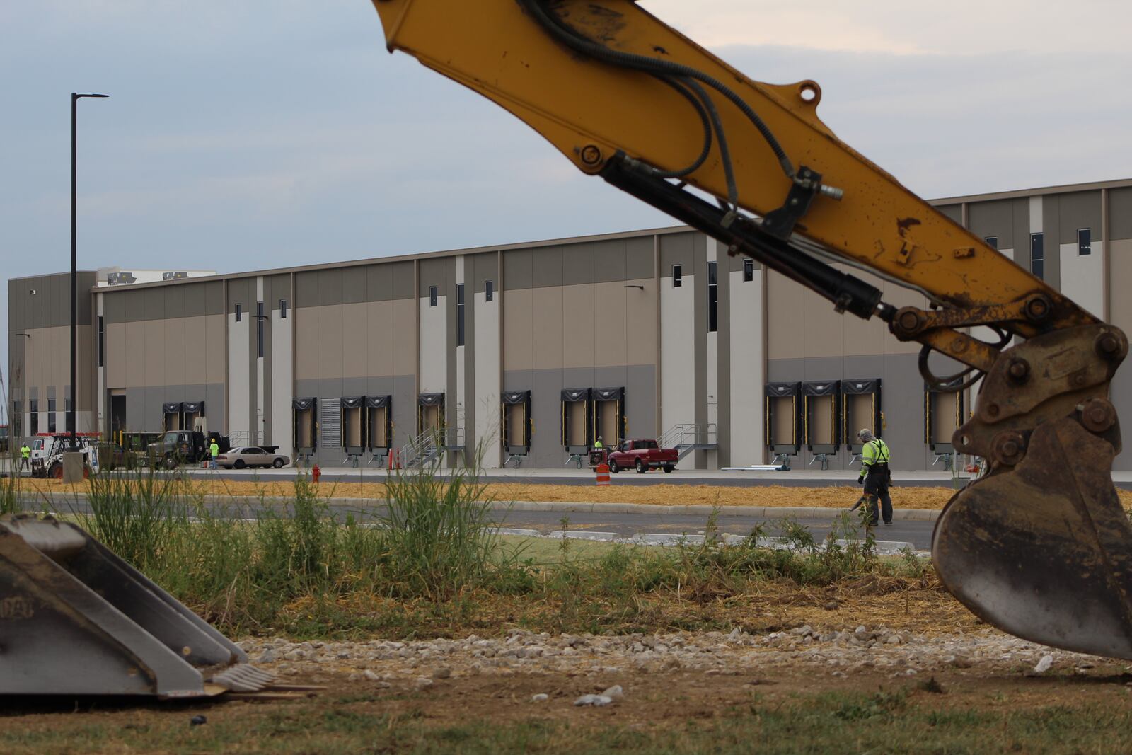 Crews work outside of a building under construction near the Dayton International Airport. FILE PHOTO. CORNELIUS FROLIK / STAFF