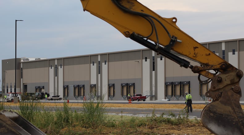 Crews work outside of a building under construction at the Dayton International Airport by NorthPoint Development. The company wants to build a fifth building at the airport. CORNELIUS FROLIK / STAFF