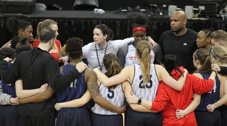 Dayton huddles with coach Shauna Green after practice on Thursday, March 15, 2018, at the KFC Yum! Center in Louisville, Ky.