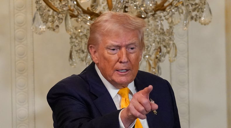 President Donald Trump gestures during a Black History Month event in the East Room of the White House, Wednesday, Feb. 18, 2026, in Washington. (AP Photo/Nathan Howard)